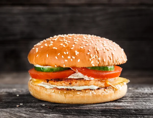 Burger with salmon patty and vegetables — Stock Fotó