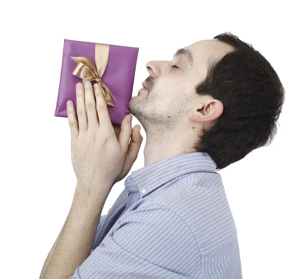 Young man holding a present — Stock Photo, Image