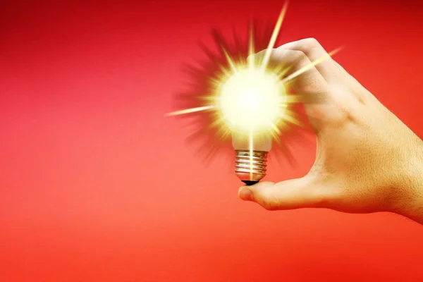 Background with lit lightbulb — Stock Photo, Image