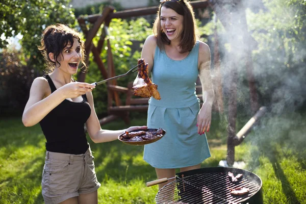 Girls making food on grill — Stock Photo, Image