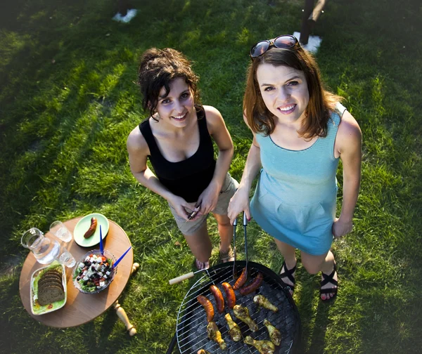 Girls making food on grill — Stock Photo, Image