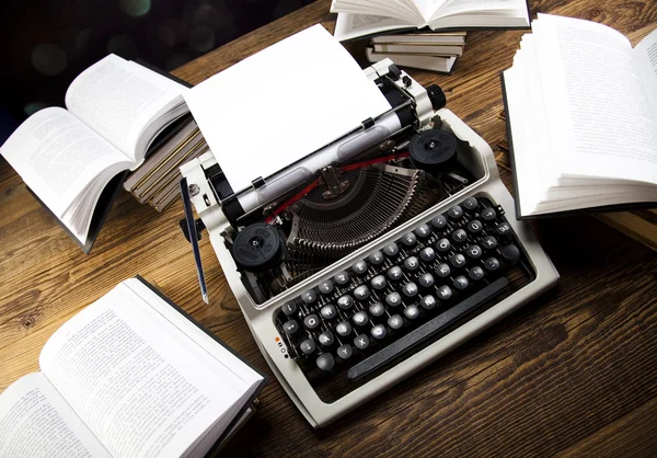 Retro typewriter with old books — Stock Photo, Image