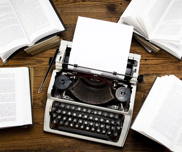 Retro typewriter with old books — Stock Photo, Image