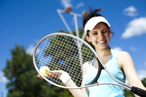 Girl standing with tennis equipment — Stock Photo, Image