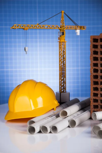 Crane, Safety helmet, Blueprints and construction site — Stock Photo, Image