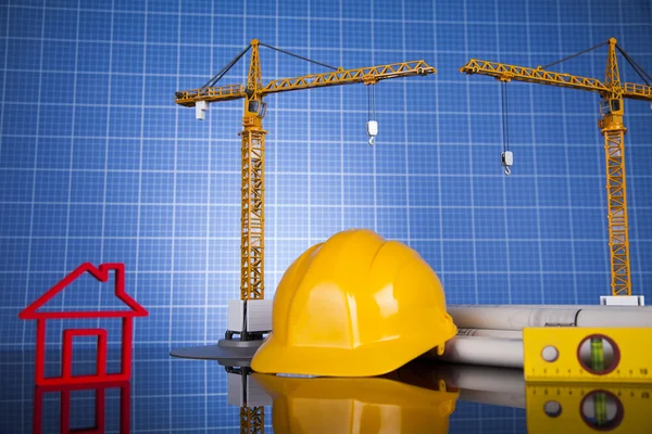 Crane, Safety helmet, Blueprints and construction site — Stock Photo, Image