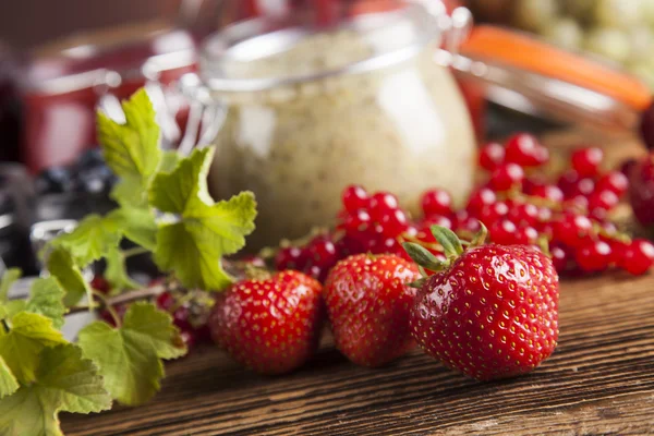 Jams in glass jars with wood and fresh berries — Stock Photo, Image