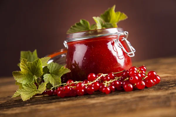 Jams in glass jars with wood and fresh berries — Stock Photo, Image