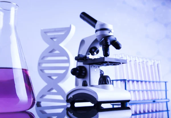 Microscope and glassware in laboratory — Stock Photo, Image