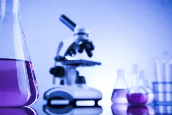 Microscope and glassware in laboratory — Stock Photo, Image