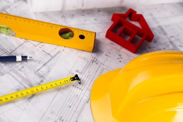 Architectural project and Yellow helmet and house model — Stock Photo, Image