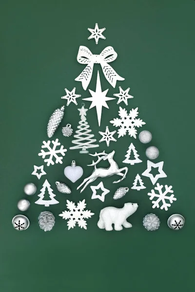 North pole themed abstract Christmas tree with frosted & silver bauble decorations on green background. Festive symbols for the holiday season. Top view, flat lay, copy space..