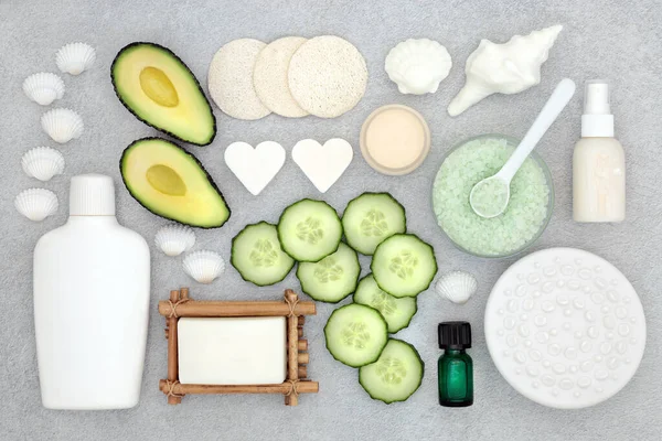 Natural organic avocado & cucumber beauty treatment products for skincare with vegan cruelty free ingredients. Flat lay on mottled grey background.