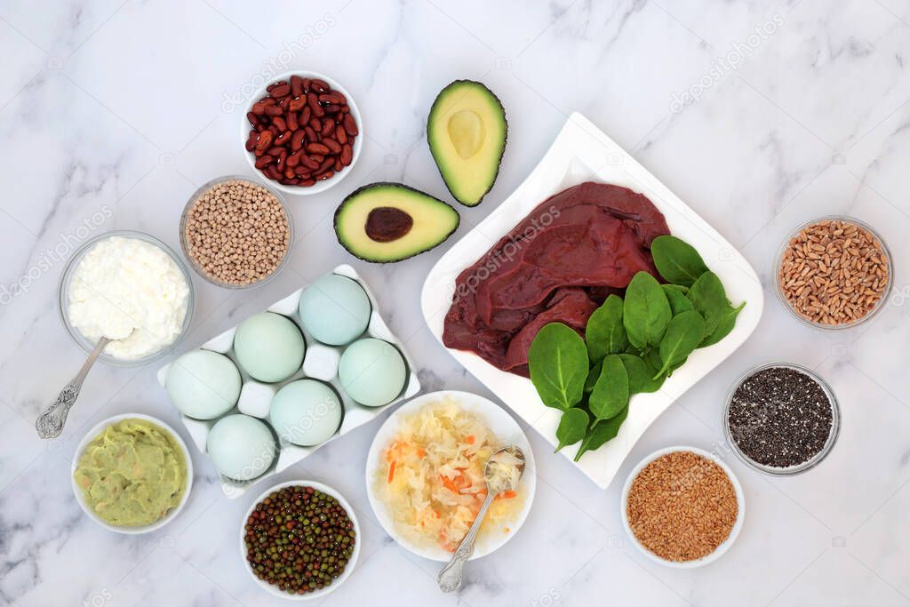 Health food to help bi polar disorder & manic depression high in omega 3, protein, selenium, magnesium, serotonin & tryptophan. Dairy, meat, seeds, legumes, vegetables, grains. Flat lay on marble.