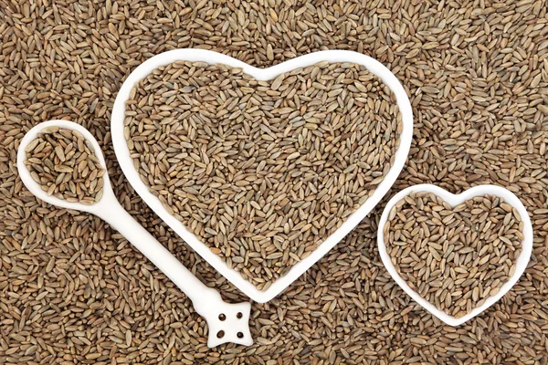 Rye Grain in Heart Shaped Dishes and Spoon — Stock Photo, Image