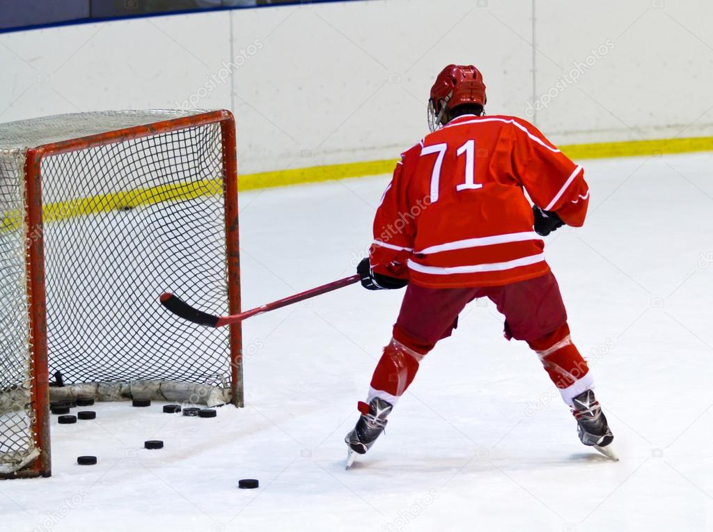 hockey player near the ice hockey net