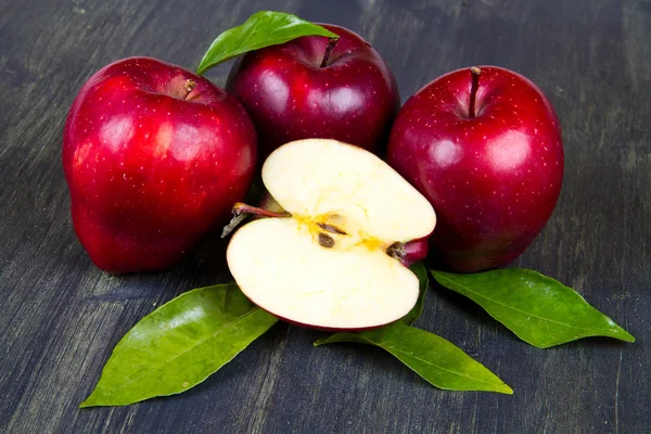 Rote Äpfel auf einem Holztisch — Stockfoto