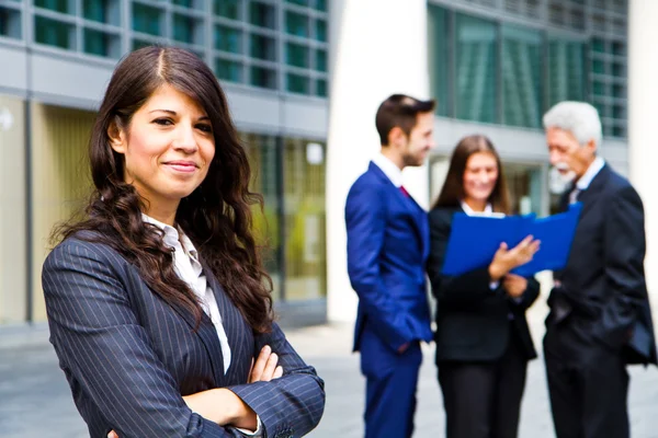 Beautiful woman with business people as background Royalty Free Stock Images