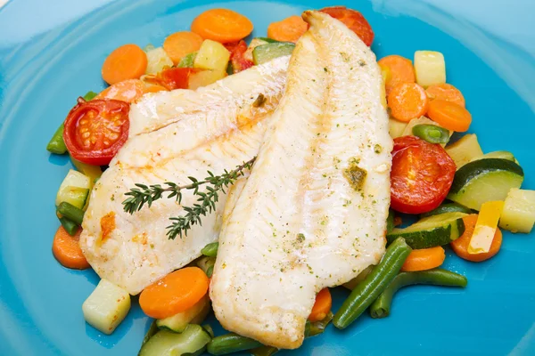 Fresh cod on bed of mixed vegetables — Stock Photo, Image