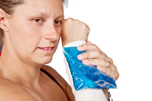 Woman's arm with bandage and ice painkiller — Stock Photo, Image