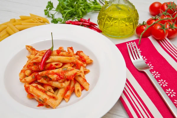 Dish with penne and arrabbiata sauce — Stock Photo, Image