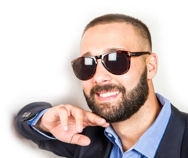 Handsome young man in a business suit leaning the wall — Stock Photo, Image