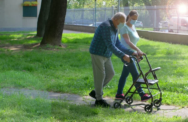 Young Caregiver Accompanies Elderly Gentleman Helping Him Walk Park — Stock Photo, Image