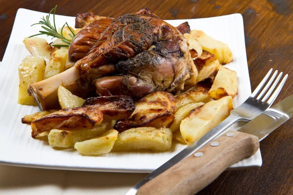 Pork knuckle baked with  potatoes — Stock Photo, Image
