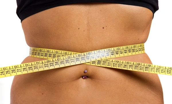 A slim girl measuring her waist — Stock Photo, Image