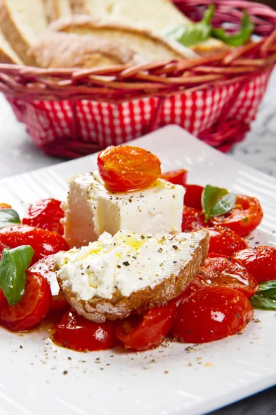 Goat cheese with tomatoes — Stock Photo, Image