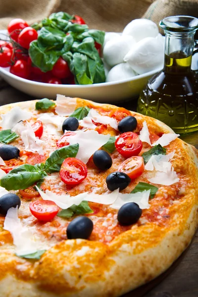 Delicious fresh pizza served on wooden table — Stock Photo, Image