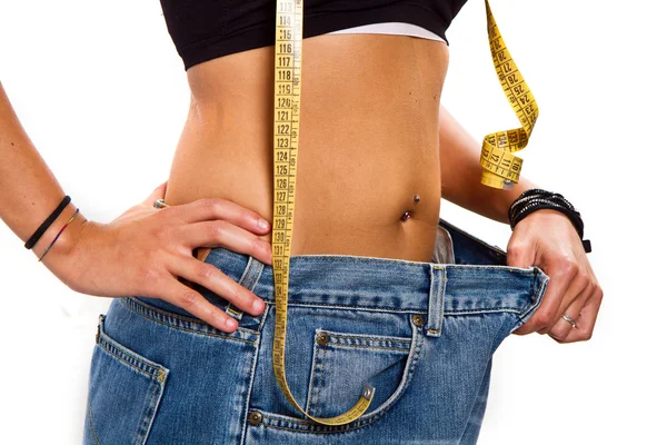 A slim girl measuring her waist — Stock Photo, Image