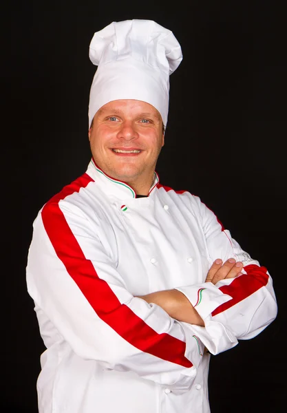 Szép chef jelentő fekete háttér ellenében — Stock Fotó