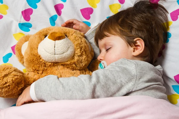 Sweet child sleeping with teddy bear — Stock Photo, Image