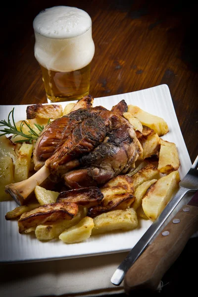 Pork knuckle baked with potatoes — Stock Photo, Image