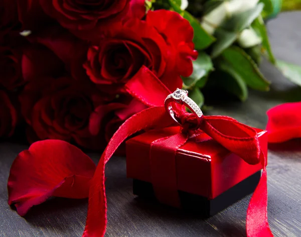 Valentinstag rote Rosen und Geschenkbox auf einem hölzernen Hintergrund — Stockfoto