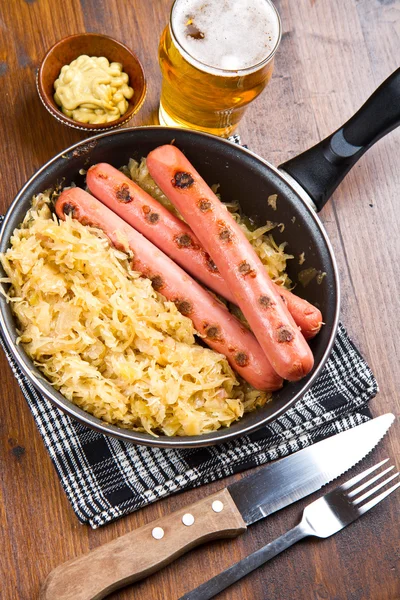 Dish with roasted wurstel and sauerkraft — Stock Photo, Image