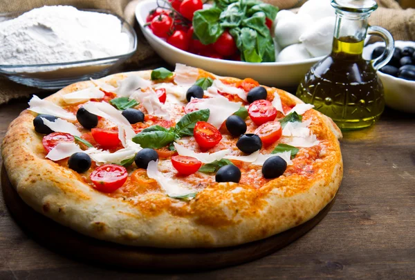 Heerlijke verse pizza geserveerd op houten tafel — Stockfoto