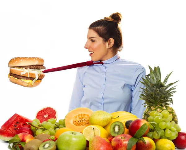 Diet: a beautiful girl with vegetables and hamburger — Stock Photo, Image