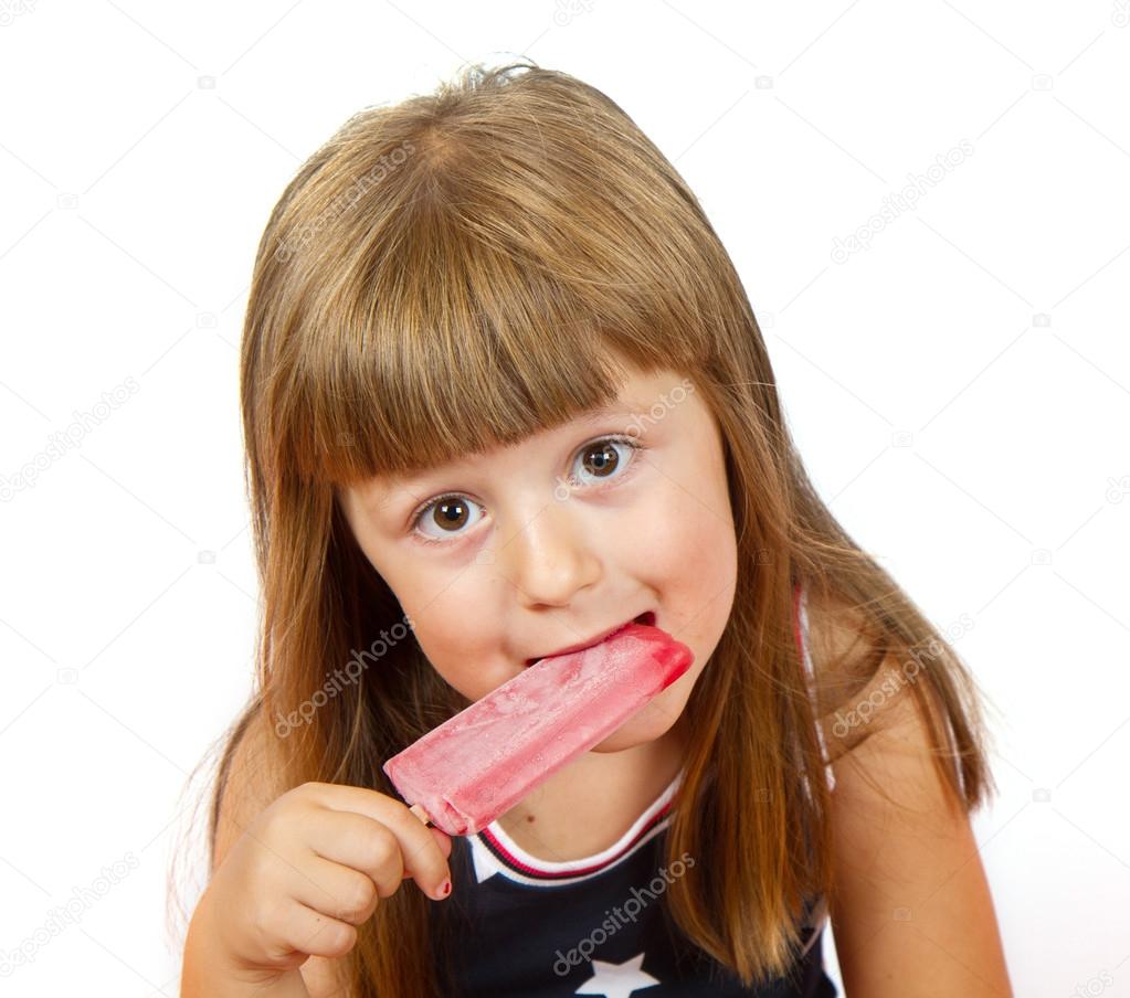 Little girl eating colorful ice lolly