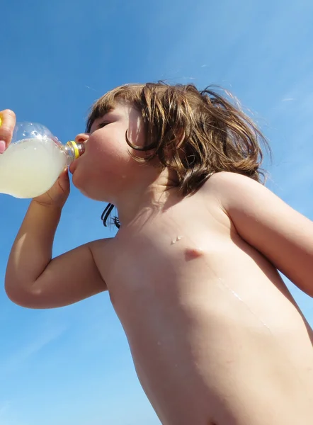 Little girl drinking by bottle — Stock Photo, Image