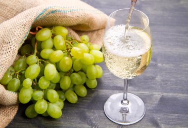 Yeşil üzüm demet ve ahşap arka plan üzerinde şarap