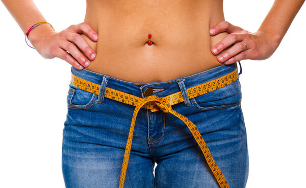 a slender young woman in jeans with a tape measure after a succe