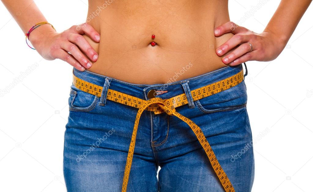 a slender young woman in jeans with a tape measure after a succe