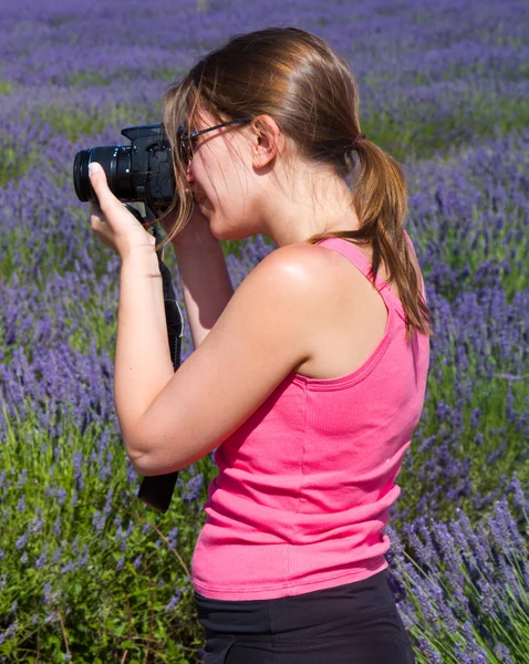 Beautiful woman among lavender photographing some lavender flowe — Stock Photo, Image