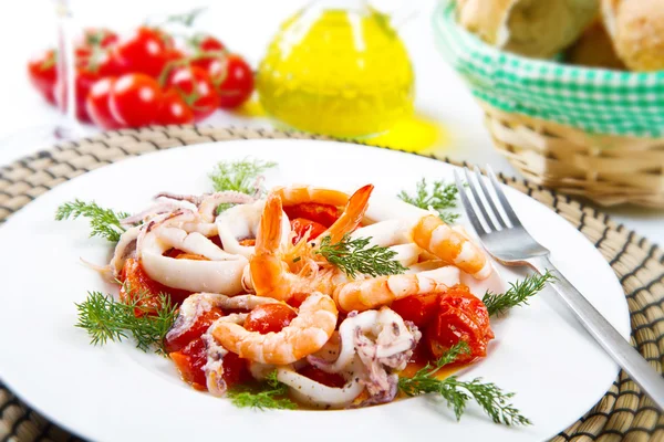 Dish with tomatoes and squid — Stock Photo, Image