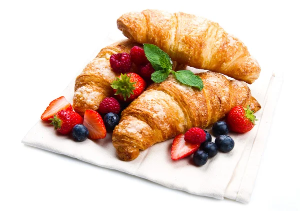 Fresh tasty croissants with berries on white background — Stock Photo, Image