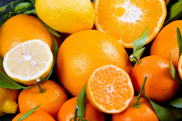 Frutas de laranja, tangerinas frescas laranjas e citrinos sobre madeira — Fotografia de Stock