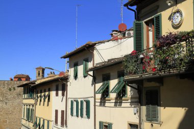 A vibrant view of Florence's historic architecture lining the Arno River, Italy