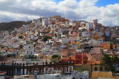 Gran Canaria 'daki Las Palmas kıyı kasabasının çarpıcı hava perspektifi, geleneksel kırmızı çatılı binalar, tarihi mimari ve tepe üstü bir kale.